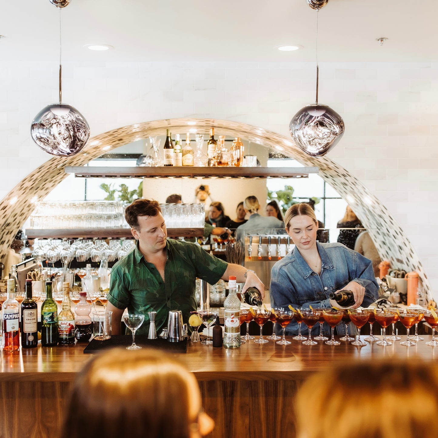 2 bartenders pouring at the Event Space bar