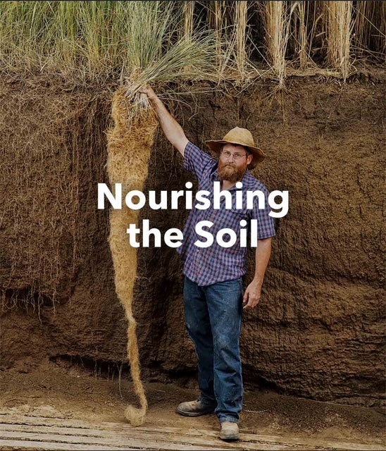 Man holding a bundle of straw next to a large pile of soil with text 'Nourishing the Soil'.