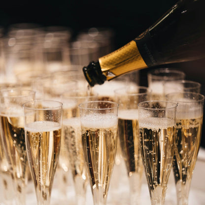 Champagne being poured into flutes with a blurred background
